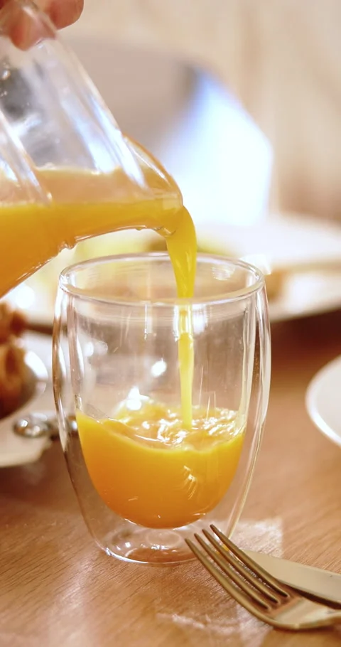 People, hands or pouring with orange juice on dining table for vitamin C drink 스톡 동영상 337928146