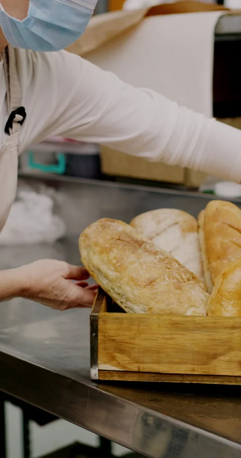 People, hands or writing with bread in bakery for inventory, food production or Stock Footage 334935832