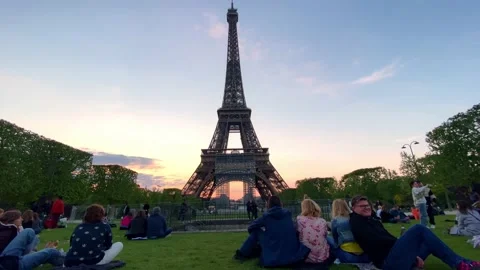 People Hang Out At Champ de Mars With Eiffel Tower In The Background At Stock Footage 218590080