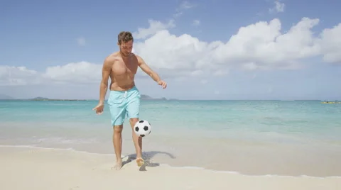 People having beach fun - Man playing football juggling soccer ball Stock Footage 46952629