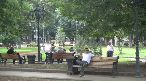 People having a break in 9 April Park in Tbilisi Stock Footage 66588435