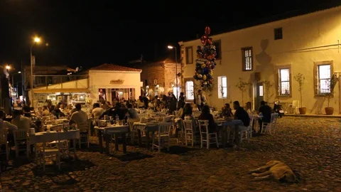 People having dinner outside in old town of Cunda (Alibey) island. Stock Footage 87621248
