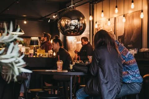 People having drinks inside Joe and the Juice cafe in Hampstead, London, UK. Stock Photos