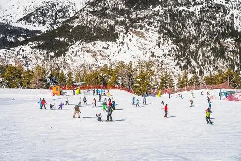 People having fun and learning how to ski and snowboard on El Tarter green slops Foto stock