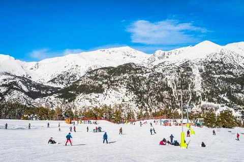 People having fun and learning how to ski and snowboard on El Tarter green slops Stock Photos