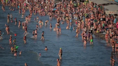 People having fun on the beach. A lot of people in the sea. Timelapse Stock Footage 79315077