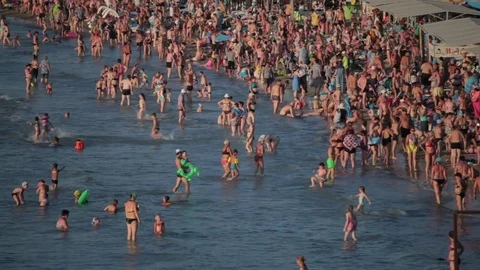 People having fun on the beach. A lot of people in the sea. Holiday. Stock Footage 79315228