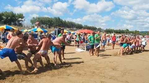 People having fun on the beach playing tug of war Stock Footage 70612111