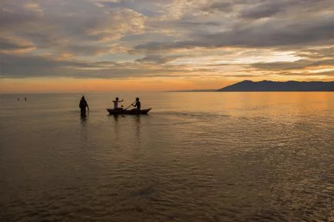 People having fun at the beach at sunset Stock Photos