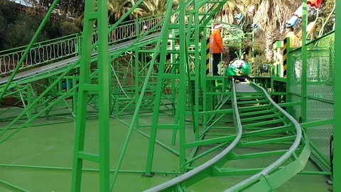 People having fun on a caterpillar Roller coaster in a Fun park in Rome, Video stock 107666531