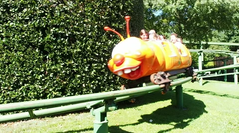 People having fun at childish roller coaster Stock Footage 66692674