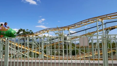 People having fun at childish roller coaster Stock Footage