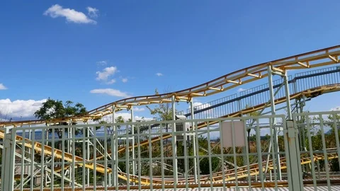 People having fun at childish roller coaster Stock Footage