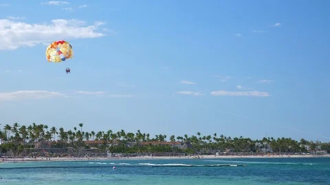 People having fun doing parasailing above Caribbean Sea Video stock 117472890