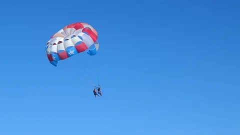 People having fun doing parasailing above Caribbean Sea Stock Footage 138179555