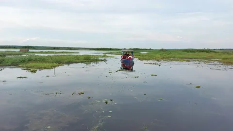 People having fun driving and discovering places with a traditional boat. Stock Footage 223439591