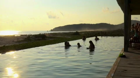 People having fun in a front ocean pool Stock Footage 46224981