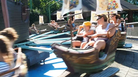 People having fun at full speed at peter pan attraction in Gardland Stock-Footage 66718337