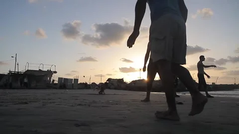 People having fun with games on the beach at sunset Stock Footage 148624579