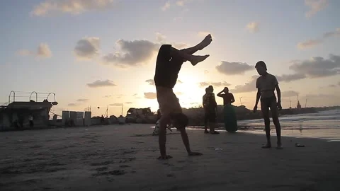 People having fun with games on the beach at sunset Stock Footage 148624831