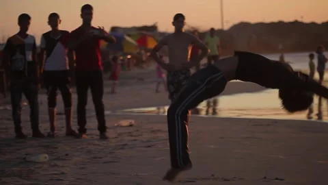 People having fun with games on the beach at sunset Stock Footage 148624981