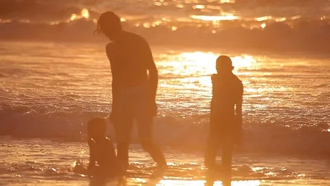 People having fun with games on the beach at sunset Stock Footage 148625161