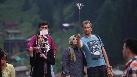 People having fun in the highlands. Selfie photos are taken. Speaking to friends Stock Footage 148884477