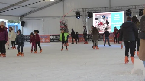 People having fun in ice skating rink Stock Footage 123804321