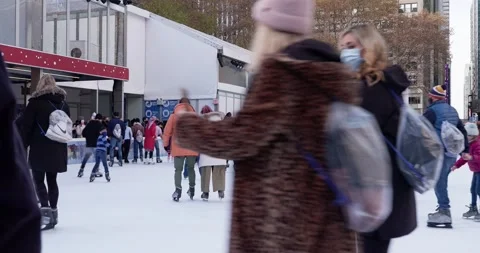 People having fun ice skating in NYC. Tourist ice skating in Bryant park Stock Footage 219892998