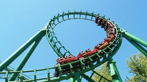People having fun looping at roller coaster called magic mountain Stock Footage 66689581
