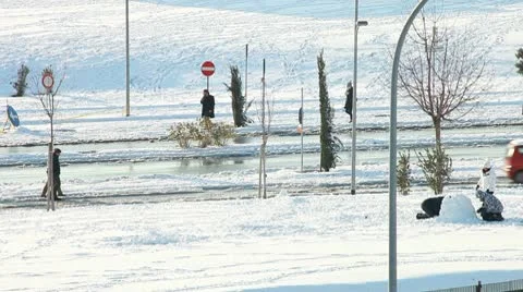 People having fun making a snowman in snow outdoors. Stock Footage 10741923