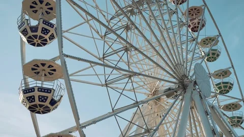 People having fun riding a ferris wheel at the amusement park on a sunny day Stock Footage 239669458