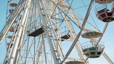 People having fun riding a ferris wheel at the amusement park on a sunny day Stock Footage 239669467