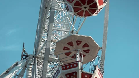People having fun riding a ferris wheel at the amusement park on a sunny day Stock Footage 239669501
