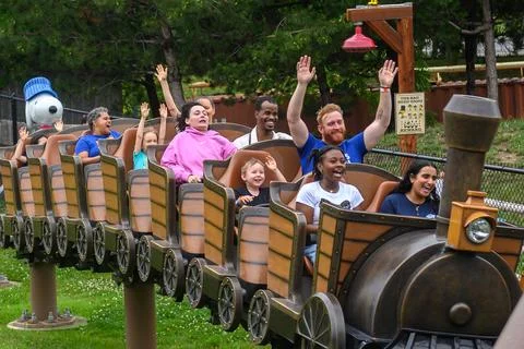 People having fun riding a roller coaster at Wonderland Stock Photos