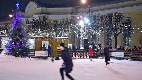 People having fun skating in the skating rink in evening Stock Footage 168409488