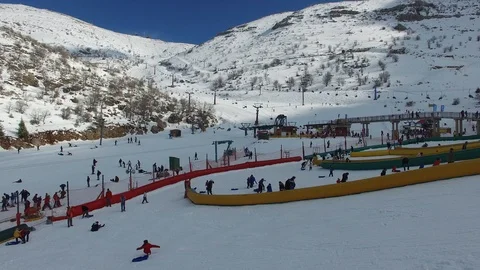 People at having fun in the snow of Mt. Hermon Ski Resort. Israel. DJI-0061-01 Stock-Footage 123856547