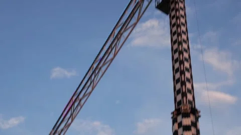 People having fun on a thrill ride swinging against blue sky Stock Footage 340280735