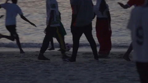 People having fun while playing soccer on beach at dusk Stock Footage 85776606