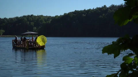 People having a good time on the small wooden raft Stock Footage 64683046