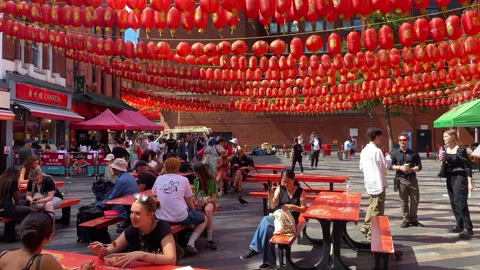 People having lunch under hundreds of red lanterns in Chinatown, central London Video stock 320297447