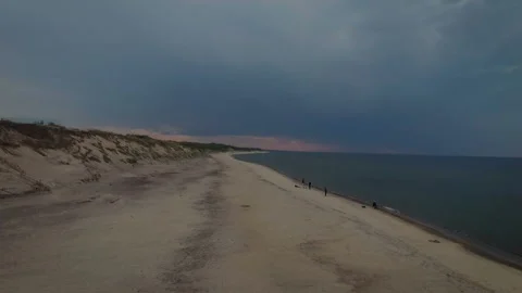 People having a rest on the beach in the evening admiring the osean. Shooting in Video stock 93784679