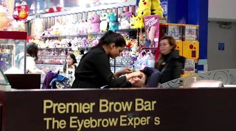 People having threading tint waxing at Premier brown bar Stock Footage 65215319