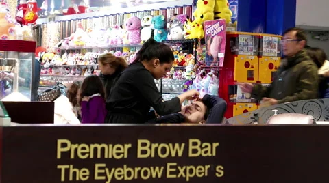 People having threading tint waxing at Premier brown bar Stock Footage 65221160