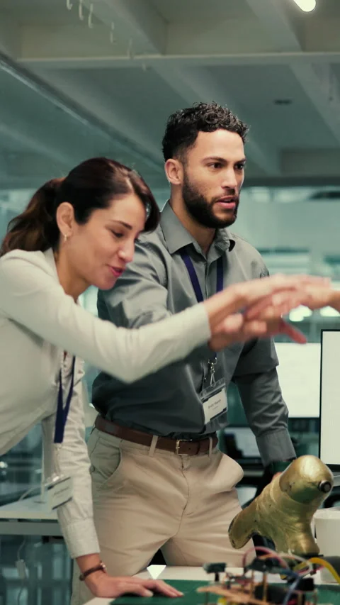 People, high five and design with prosthetic in lab with robotics, pile and Stock Footage 332917858