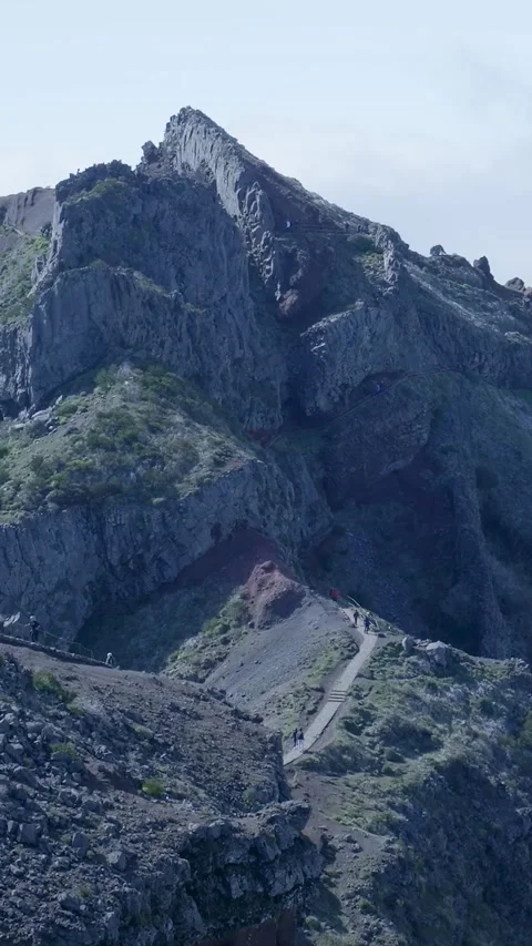 People hiking a dramatic mountain path in madeira Stock Footage 334443801