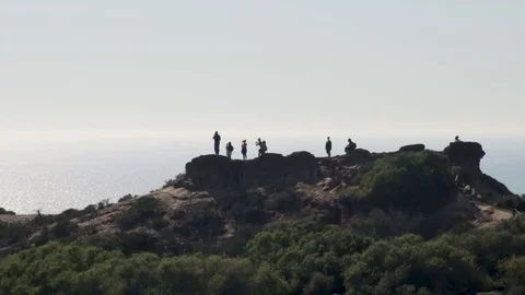 People on a hill over the ocean Stock Footage