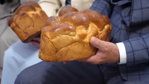 People hold traditional bread in their hands to bless the bride and groom. Video stock 310944977
