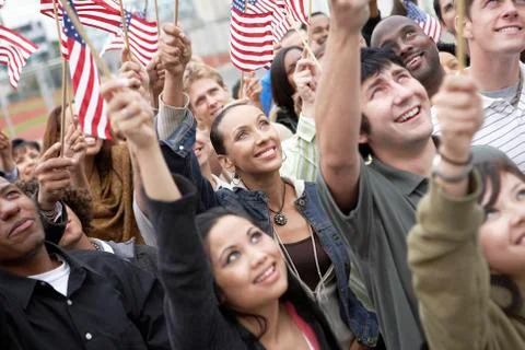 People Holding Up American Flags Stock Photos