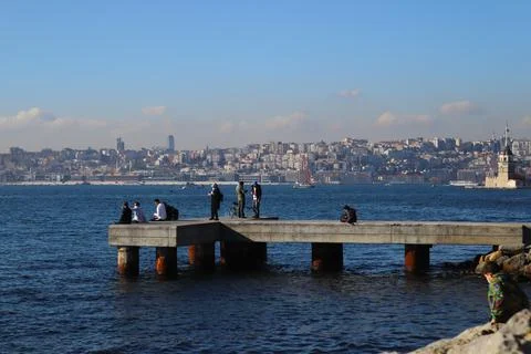 PEOPLE HOLDING FISH AT THE STONE PIER IN ÜSKÜDAR Stock Photos